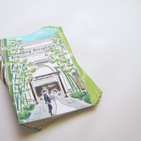 横浜迎賓館エントランスにいる新郎新婦のイラストが描かれた冊子の表紙